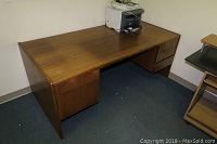 Overall view of the wood desk showing top surface and drawer unit on the right.