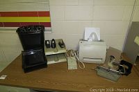 View of all items on table including printer, hole punch, stapler, trash can and book ends.