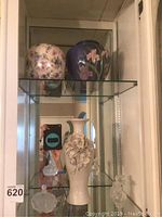 Shelf with three vases and two glass perfume bottles with stoppers, showing tall cream vase with floral applique, two smaller round vases, and clear glass perfume bottles.