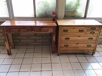 Full view of the wooden entry table with three drawers on the left and wooden dresser with five drawers on the right, both showing surface scratches and wear.