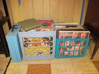 Photo shows three containers containing many vinyl records, visible artists include Linda Ronstadt and others along with a blue plastic case.