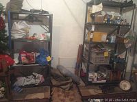 Front view showing both metal shelving units placed next to each other in a basement or storage area, some items on shelves but not included in lot.
