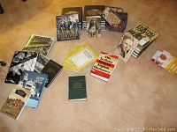 Overview of various history books, dictionaries, and magazines on the floor including Civil War and Baltimore topics.