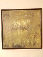 Frontal view of square abstract painting in dark wood frame hung on wall