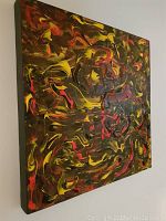 Side angle view showing thick textured paint application and depth of canvas edges painted black.