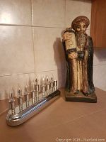 Electric Menorah alongside Rabbi statue showing size and condition under natural light