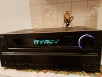 Front panel of Onkyo AV receiver showing it powered on with FM radio frequency 101.3 MHz display.