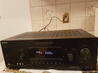 Front view showing digital display reading FM 99.0 and overall front panel