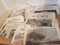 Stack of The Times Science Review issues showing covers with scientific and industrial images, dated from the 1950s.