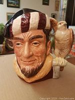 Front view of Royal Doulton The Falconer character jug, showing facial details and falcon on shoulder.
