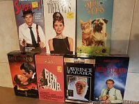 Seven classic VHS tapes displayed showing titles and covers