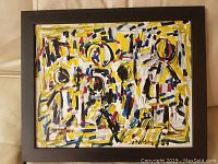 Frontal view of framed abstract painting in black frame
