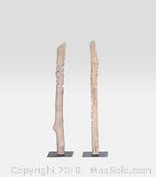 Two vertical natural wood sculptures mounted on metal bases shown against a plain white background.