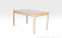 White oak rectangular dining table with four legs visible from a slight angle.