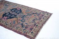 Full view of vintage 3x5 area rug showing its overall pattern, coloration, and condition