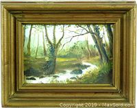Front view of the painting titled 'Woodland Scene' by LR Branwell, showing the woodland landscape with trees and a flowing stream, all enclosed in a gilded wooden frame.