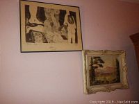 Two framed artworks on wall: framed lithograph at top left, ornate framed landscape painting at bottom right