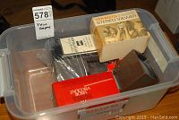 Plastic bin containing multiple slide viewers and related accessories including manuals and original boxes.