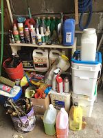 Shelf and floor display of motor oils, engine lubricants, spray cans, watering cans, funnels, pails, and storage containers