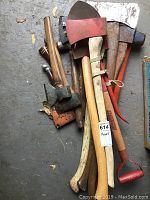 Overview of all tools laid out showing axes, hatchets, shovel and mallet