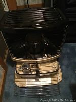 Front view of the vintage beige and black Sunbeam kerosene heater showing control panel and metal protective grill.