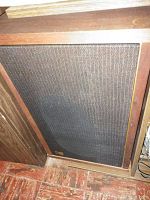 Front view of cloth-grille speaker installed in faux wood console