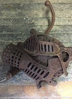 Top view of cast iron antique corn sheller showing ventilated body and hand crank.