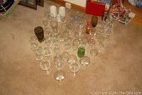 Top view of entire collection laid out on carpet, showing variety of glasses and candle holders