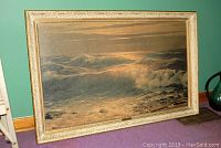 Full view of the framed print showing the ocean wave seascape in an ornate gold frame.