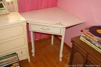 Front and side view of the painted corner table showing drawer and metal pull.