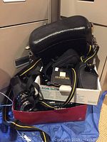 Overview of lot contents including camera bag, lenses, flash box and filters