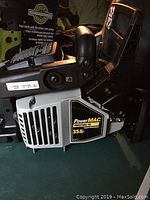 Side view of chainsaw engine and main body with PowerMAC 35cc label