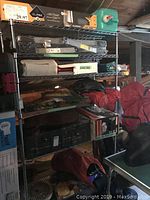 Full view of metal wire shelving unit holding various items and boxes, showing dimensions and structure.