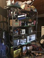 Full view of six-shelf metal wire shelving unit loaded with various items showing shelf construction and size.