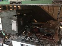 Metal toolbox shown closed with dark exterior and green interior lid.