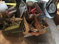 Overview of various automotive and utility items including jacks, jumper cables, sun shades, straps, and storage bins.