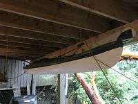 Full-length side view of kayak hung under deck