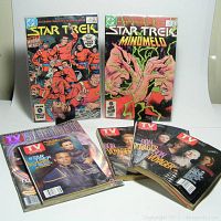 Two vintage Star Trek comics and five Star Trek-themed TV Guide magazines arranged on a white surface.