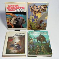 Four vintage science fiction and fantasy hardcover books with dust jackets arranged in a group.