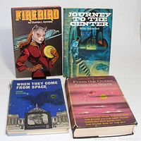 Four vintage hardcover science fiction books with colorful dust jackets visible from front cover and top edges