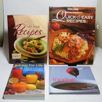 Four cookbooks arranged in two rows: Tastefully Simple Recipe Binder, Southern Living Our Best Quick & Easy Recipes hardcover, Juicing for Life paperback, Fondue by Fiona Smith hardcover with dust jacket.