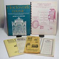 Photo showing the Clockwork Music book and four assorted antique phonograph-related pamphlets laid out together, clearly visible titles and illustrations.