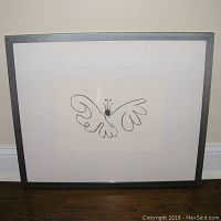 Front view of Picasso "Butterfly" framed print showing black line butterfly drawing with white matting and dark frame