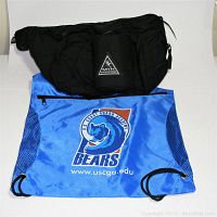 Photo showing the black MTN Cannondale biker waist pouch on top of the blue Coast Guard Bears drawstring bag.
