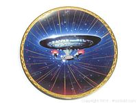 Collector plate featuring USS Enterprise NCC-1701-D in space with light rays and starfield background, circular with gold rim.