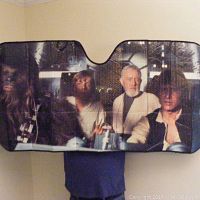 Full view of folded-out car sunshade showing characters Chewbacca, Luke Skywalker, Obi-Wan Kenobi, Han Solo