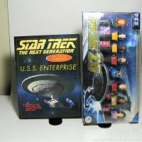 Front image of the Star Trek TNG U.S.S. Enterprise Make Your Own Starship kit alongside the Star Trek TNG 25th Anniversary Pez set with multiple character dispensers and USS Enterprise ship Pez container.