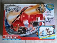Boxed Robots Super City motorized playset with robot figures and track visible on packaging front.