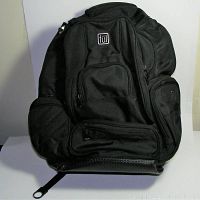 Full front view of black Ful padded laptop backpack showing multiple front compartments and zippers.