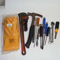 Photo of Ridgid pipe wrench, Kobalt hammer, various screwdrivers, socket handle, and new Atlas waterproof gloves.